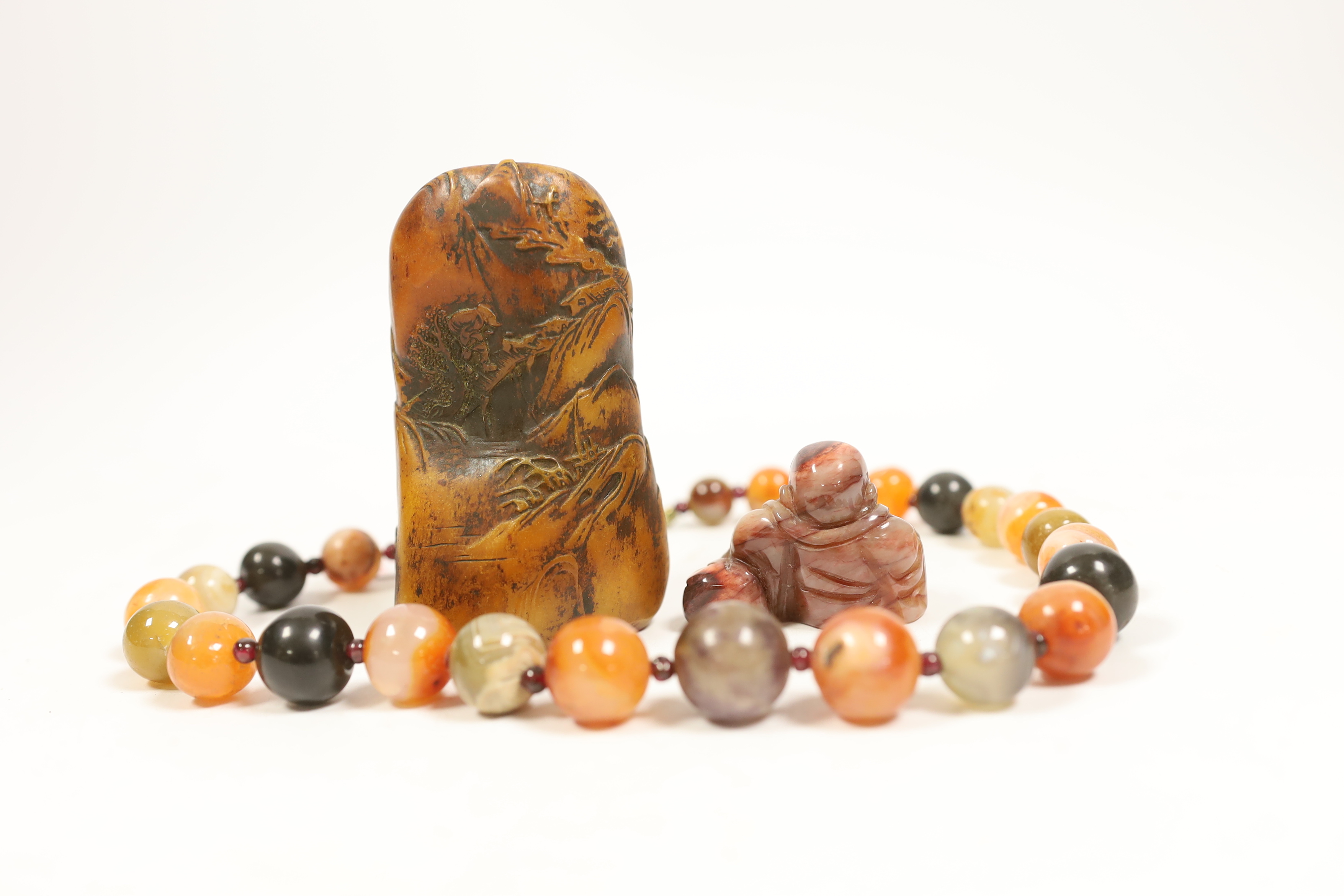 An agate bead necklace, a Chinese soapstone seal and a miniature carved agate Buddha, 4cm